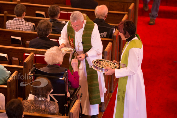 Pr. Dale and Pr. Gena serve communion to Leona Miller